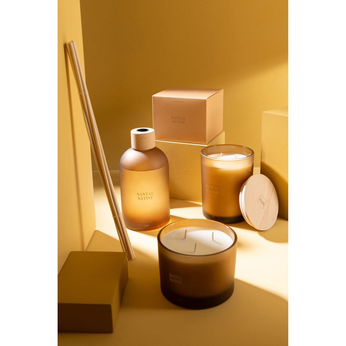 Geurkaars Accords Essentiels Santal Satiné 52 Uur van J-Line samen met bijpassende geurstokjes uit de Santal Satiné lijn